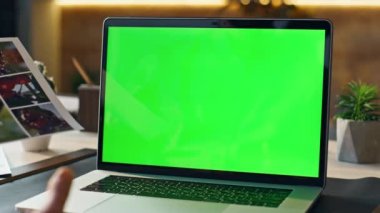 Tanımlanamayan yönetici yeşil ekran laptop video konferansında çalışmayı tartışıyor. İş adamı bilgisayar kamerasına tasarım örnekleri gösteriyor. Çevrimiçi toplantıda Freelancer konuşuyor.