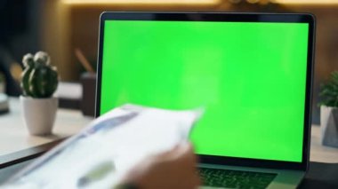 Bilinmeyen yönetici ofisteki yeşil ekran laptopunda görüntülü konuşma yapıyor. Şirket çalışanı internet konferansında konuşuyor. İş örneklerini bilgisayar kromunda tutuyor. Çalışan tasarım projesini sunar.