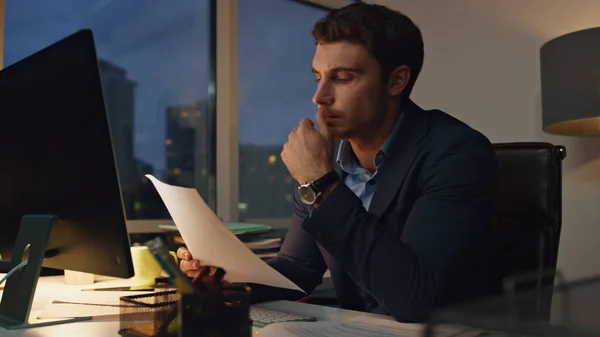 Company executive working late in office closeup. Tired manager checking report thinking project. Handsome lawyer financial broker overworking suffering headache. Corporate people lifestyle concept