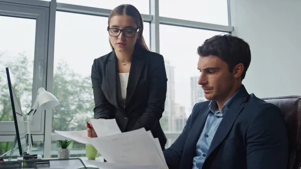 stock image Upset workers check documents in office. Two colleagues talking analysing data papers together. Thoughtful ceo business partners discussing financial report problems. Team cooperation concept.