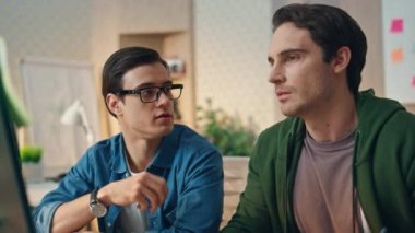 Birlikte bilgisayar projesini tartışan meslektaşlar. Yakın plan. Ofisteki elemanlar masa başında beyin fırtınası yapıyorlar. Yaratıcı web tasarımcısı hipster kabinesinde iş arkadaşı konuşuyor. Takım çalışması konsepti 