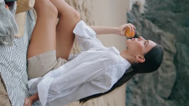 Menina Relaxada Comendo Maçã Praia Piquenique Sentado Cobertor Dia Nublado — Vídeo de Stock
