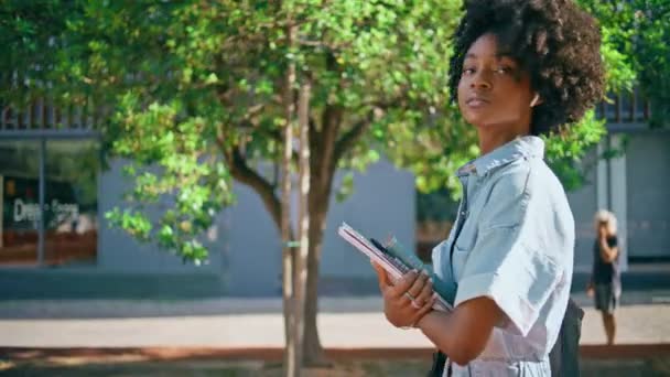 African American Teenager Walking Sunny City Holding Books Close Beautiful — Stock Video