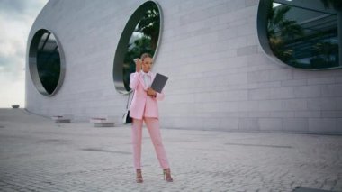 Ofis binasının yanında klasörlü cep telefonundaki sesli mesajları dinleyen bir yönetici. Kendine güvenen zarif iş kadını dışarıdaki akıllı telefondan sesli mesaj alıyor. Modern telefon uygulaması.