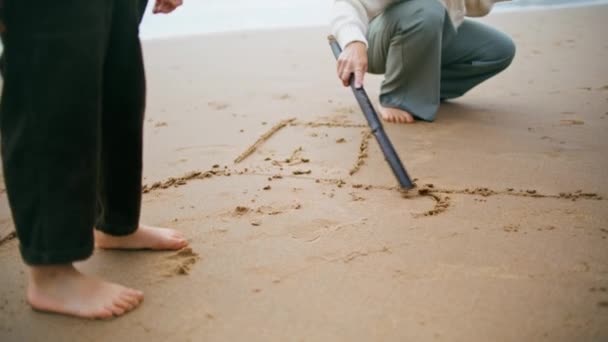 Closeup Hand Draw Beach Sand Family Weekend Unknown Boy Legs — Stock Video
