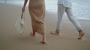 Sweethearts feet running sand beach at sea vacation. Unrecognizable playful couple walking on shore outdoors. Two lovers legs going out nature landscape background closeup. Relax recreation concept