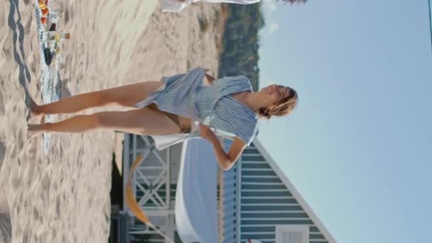 비디오 소녀는 해안에서 휴가를 보내고 비키니에 일광욕 휴가를 즐기는 수직으로 — 비디오