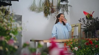 Çiçekçi dükkanında mutlu çiçekçi kız konuşmaları. Çekici bir işletme sahibi buket fabrikasında çalışıyor. Pazar yerinde genç bayan girişimci satışı. Güzel bir kız işten zevk alır. Yaratıcı çiçek kavramı.