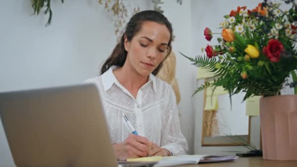 Fokuserad Kvinna Skriver Arbetsidéer Projekt Papper Anteckningar Blomsteraffär Företag Närbild — Stockvideo