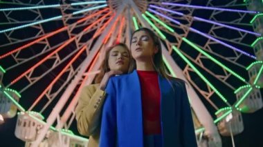 Mankenler gece vakti eğlence parkına poz veriyor. Dönme dolapta dinlenen güzel kızlar hafta sonları atlıkarınca aydınlatırlar. Muhteşem kız arkadaşlar Neon Funfair Caddesi 'nde kameraya bakar. Eğlence konsepti