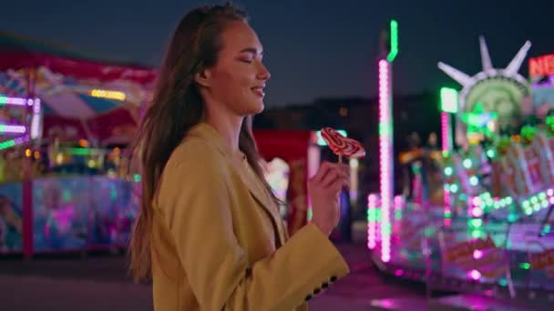 Happy Girl Walking Amusement Park Sweet Lollipop Smiling Model Enjoying — Stock Video