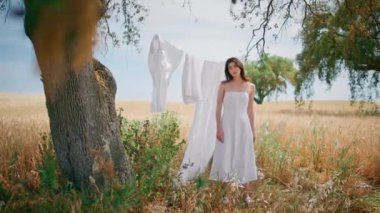 Vahşi doğa bahçesinde çamaşırlarını kurutan kırsal bir kadın. Çavdar tarlasına bakan ve yaz sıcağından zevk alan nazik bir kız. Kırsal kesimdeki köyde saçlarına dokunup poz veren baştan çıkarıcı bir kadın.