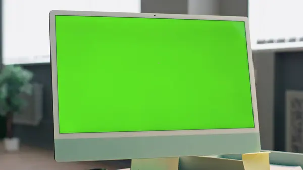 Zoom out mockup monitor in office. Close up unknown employee talking chroma key device having online meeting in workplace rear view. Anonymous businessman chatting greenscreen pc working in open space
