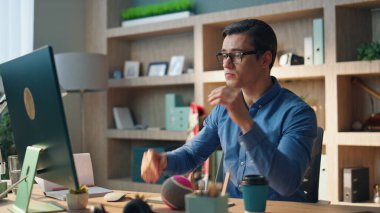 Mutlu iş adamı, iş dünyasının internet röportajını yakından konuşuyor. Gülümseyen yönetici, video konferansı sağlayan kameraya el hareketi yapıyor. Ofiste internet toplantısından keyif alan neşeli bir adam. 