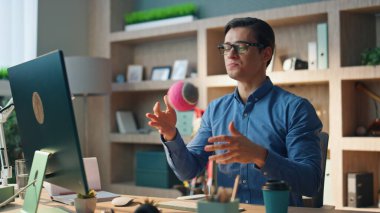 Ofisteki arkadaş canlısı serbest çalışan bilgisayardan arıyorum. Çevrimiçi meslektaşlarına stratejiyi açıklayan sunumu yapan gülümseyen adam. Kabinede el kol hareketi yapan gevşek profesyonel bir top. 