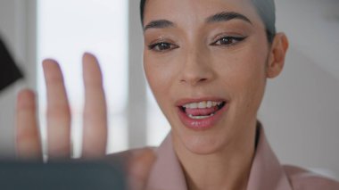 Konuşan blogcu evde cep telefonu kamerasını gösteriyor. İnternet işitsel kayıt video blogu ile iletişim kuran mutlu bayan. Çevrimiçi canlı yayın yapmayı öğrenen olumlu kadın nüfuzlu biri.