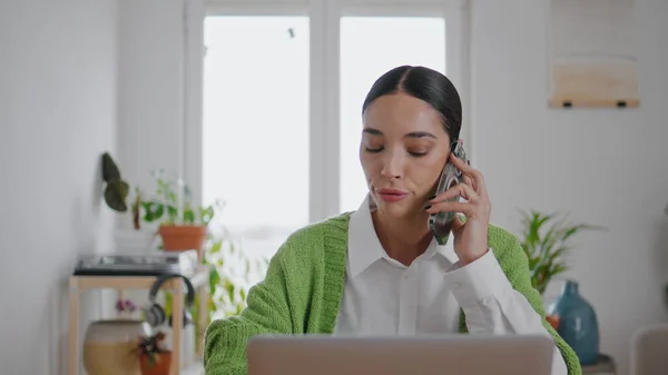 Annoyed woman speaking mobile phone at home office closeup. Mad businesswoman calling partner solving work crisis problems. Angry bank client customer explain complain. Disappointed lady talking cell