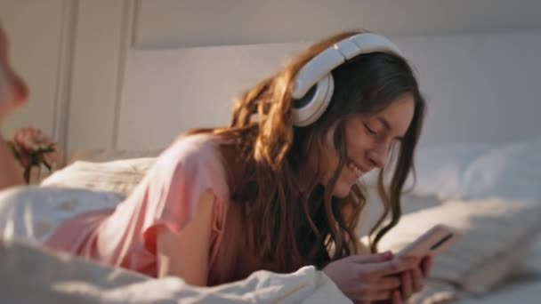Gadis Rumah Mendengarkan Headphone Bawah Sinar Matahari Carefree Model Berbaring — Stok Video