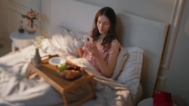 Calm Girl Enjoying Breakfast Drinking Coffee Bed Relaxed Female Surfing — Stock Video