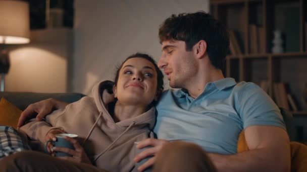 Cute Couple Watching Movie Sitting Cozy Apartment Night Close Smiling — Stock Video