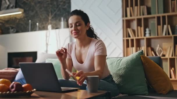Girl Freelancer Rejoicing Notification Payroll Smartphone Sitting Modern Living Room — Stock Video