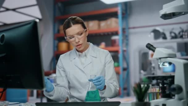 실험실 촬영에서 플라스크 샘플을 과학자 심각한 미생물학 전문가 물질을 과학적 — 비디오