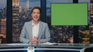 Pozitif haber sunucusu akşam kromakey TV kanalının yakın çekimini konuşuyor. Sunucu kadın yeşil ekran görüntüsü yayınlıyor. Güzel spiker dizin sonu model ekran yayın arkaplanı alıyor