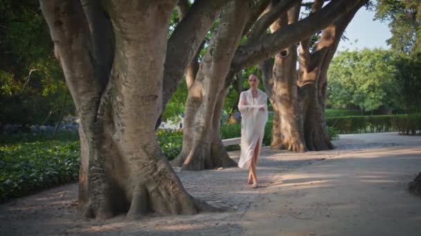 Мечтательная Женщина Прогуливающаяся Парку Завернутая Белый Легкий Шарф Спокойная Молодая — стоковое видео