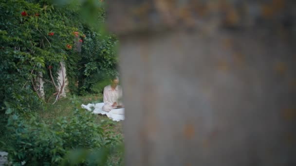 Woman Reading Romantic Literature Blanket Green Garden Relaxed Young Lady — Stock Video