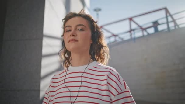 Beztroska Dziewczyna Słuchająca Muzyki Przez Słuchawki Słonecznej Ulicy Blisko Portret — Wideo stockowe