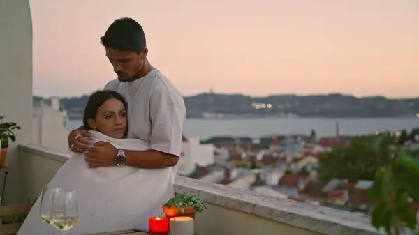 Sensual girlfriend embracing man at terrace closeup. Affectionate couple hugging enjoying romantic time. Tender newlyweds cuddling together at sunset balcony. Positive spouses bonding against sea view