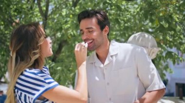 Sevgili sevgililer, Sunshine Terrace 'da yemek tadıyorlar. Işıldayan kadın yeşil ağaççıda yakışıklı adamı besliyor. Mutlu aşıklar, yaz balkonunda romantik bir randevu.