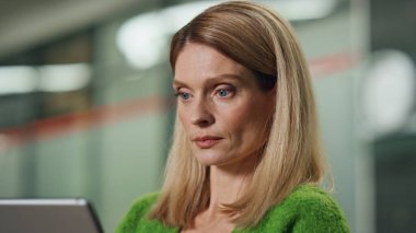 Ofis portresini izleyen düşünceli bir iş kadını. Bilgisayarda çalışan, koltuk bölgesinde e-posta okuyan odaklanmış bir kadın. Kendine güvenen bayan patron, dijital tablet ekranda tek başına düşünüyor.