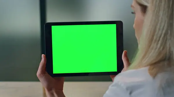 Closeup lady watching greenscreen tablet at office. Blonde woman hands holding horizontal chromakey tab in cabinet. Unknown businesswoman reading mockup computer. Boss sitting with template pad alone