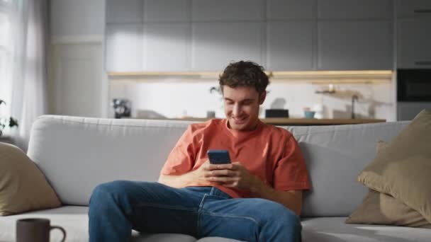 Cheerful Man Chatting Smartphone Cozy Sofa Happy Smiling Guy Creating — Stock Video