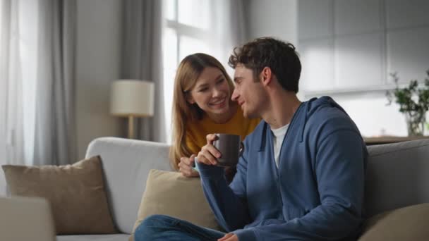 Joyful Duet Speaking Laptop Virtual Chat Drinking Tea Sofa Interior — Stock Video