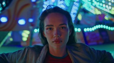 Ay parkına yakın çekim pozu veren çekici bir model. Aydınlanmış şehir karnavalında güzel bir dinlenme eğlencesi kamerası. Hayalperest güzel kadın akşam randevusundan zevk alıyor. Hafta sonu gece hayatı konsepti.