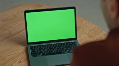 Yeşil ekran dizüstü bilgisayarı gibi görünen bir iş adamı kafe masasında çevrimiçi konferans için bekliyor. Tanımlanamayan yönetici şirket ofisinde krom anahtar monitöründe çalışıyor. Model bilgisayar kullanan meşgul işçi
