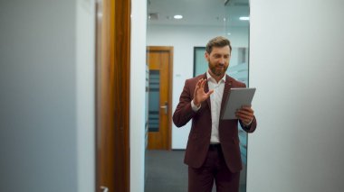 Koridorun sonundaki video görüşmesinde neşeli proje yöneticisi selamlıyor. Akıllı iş adamı tablet ekranı izlerken konuşuyor. Kendine güveni olan bir adam cam duvarda lüks bir yerde sanal bir konuşma yapıyor.