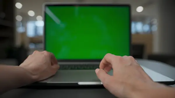 Unknown woman scrolling touchpad at chroma key laptop at lounge. Closeup office manager hands touching greenscreen device at open space. Unrecognizable ceo working online. Digital technology concept
