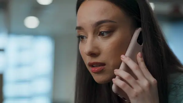 Angry woman call phone at office closeup. Annoyed person talking mobile device in raised tones. Nervous executive rejecting business idea disagree with partner. Director arguing having conversation