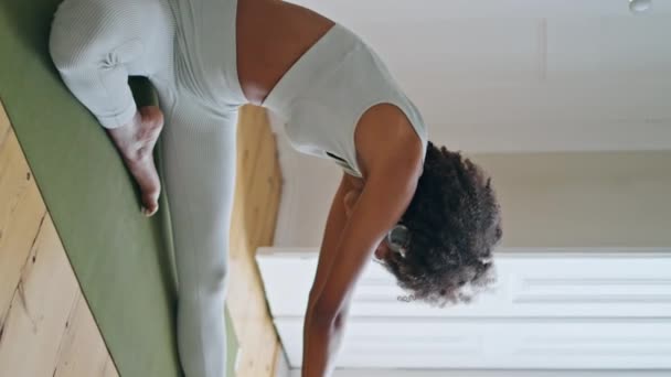 瑜伽垫中的弹性模型伸展身体 卷发运动教练员练习沙纳坐地毯垂直射击 非洲裔美国女孩独自观看平板电脑视频教学培训 和谐概念 — 图库视频影像