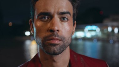 Kapalı çekim baştan çıkarıcı adam gece şehir bölgesinde kameraya özgüvenle bakıyor. Tıraşsız seksi İspanyol modelin modayla su havuzunda poz verişi. Zengin başarılı iş adamı gecenin geç saatlerinde