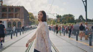 Moda mankeni caddeyi güneş ışınları kasabasında kameraya çeviriyor. Asyalı bir kadın yaz tatilinde kendini kaygısız hisseder. Çekici kaygısız kız hafta sonları sakin şehir yürüyüşünün tadını çıkarıyor. Seyahat konsepti