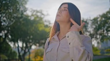 Sunny Park 'a poz veren manken sakin bir sabahta özgürlüğün tadını çıkarıyor. Yaz güneşinin altında verimli yeşillikte sakin bir yolculuk. Güzel, genç bir kadın. Sakinliği rahatlatıyor. Doğada soluklanıyor..