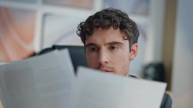 Yakın çekim odak CEO masasında sözleşme kağıtları okuma. Düşünceli yürütme planlama gelecekteki ortaklık ofiste düşünme işi. Orta yaşlı, tıraşsız erkek menajer yeni şirket projesini onayladı