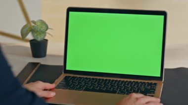 Tanımlanamayan girişimci görünümlü yeşil ekran dizüstü bilgisayar şirketin iş yerinde yakın planda çalışıyor. Bilinmeyen iş kadını ofiste kroma anahtar bilgisayarda eğitim kursunu izliyor. Kadın model aygıtı kullan 