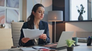 Dolapta bilgisayarla çalışan belgeyi elinde tutan üzgün bir iş kadını. Kadın CEO şirket çalışmalarından duyduğu hayal kırıklığını ifade eden iş belgelerini izliyor. Ofis müdürü masadan memnun değil. 