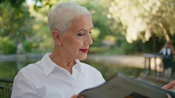 Relaxed Woman Holding Magazine City Park Closeup Grey Hair Lady Stock Picture