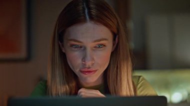 Kapalı devre kadın bilgisayar ekranında geç saatlere kadar çalışmaktan yoruldu. Karanlık ev işyerindeki laptoptan bilgi okuyan çekici, ciddi bir serbest yazar. Genç iş kadını gece geç saatlere kadar merceğe bakıyor.